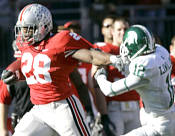 Ohio State running back Chris Wells (28) runs against Michigan State's T.J. Williams (12) during the first half of a college football game Saturday, Oct. 20, 2007 in Columbus, Ohio. (AP Photo/Kiichiro Sato)