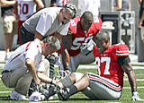 Wilson being attended to on the field during the YSU game; Wilson suffered a broken right leg defending a third-down passing play against the Penquins.
