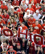 Proudly wearing their scarlet and grey, four OSU fans raise the OHIO letters during a cheer for their team at the New Orleans Convention Center for an OSU rally Sunday, January 06, 2008. .