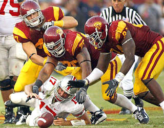 USC defensive players (from left) Clay Matthews, Fili Moala and Kyle Moore converge on a fumble by Buckeyes quarterback Todd Boeckman during the first half Saturday. (Luis Sinco / Los Angeles Times)