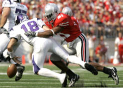 Ohio States Anderson Russell (21) sacks Northwestern quarterback C.J. Bacher (18) and causes a fumble during the first quarter of a college football game Saturday, Sept. 22, 2007 in Columbus, Ohio. Ohio States Vernon Gholston recovered the ball and ran it in for touchdown in the play. (AP Photo/Kiichiro Sato)