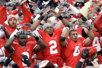 Malcolm Jenkins, left, Terrelle Pryor and Kurt Coleman and the rest of the Buckeyes sing Carmen Ohio after beating Michigan 42-7 November 22, 2008. (AP Photo/Charles Rex Arbogast)