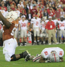 Texas offensive tackle Cedric Dockery, left, celebrates the Longhorns' winning touchdown, as Ohio State safety Anderson Russell lies on the ground following his final missed tackle in the Fiesta Bowl on Monday night as Anderson Russell lay face down on the turf  (AP Photo/ Michael Chow, The Arizona Republic)