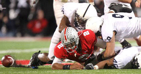 Ohio State quarterback Terrelle Pryor (2) looks at a fumble as Penn State linebacker Navorro Bowman (18), linebacker Tyrell Sales (46) and safety Mark Rubin (9) stops him during the fourth quarter of an NCAA college football game Saturday, Oct. 25, 2008 in Columbus, Ohio. The ball was recovered by Penn State. (AP Photo/Jay LaPrete)