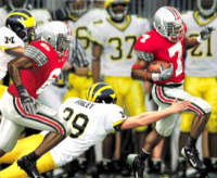 OSU Ted Ginn, Jr. runs away from Wolverine defenders in the victory over Michigan.